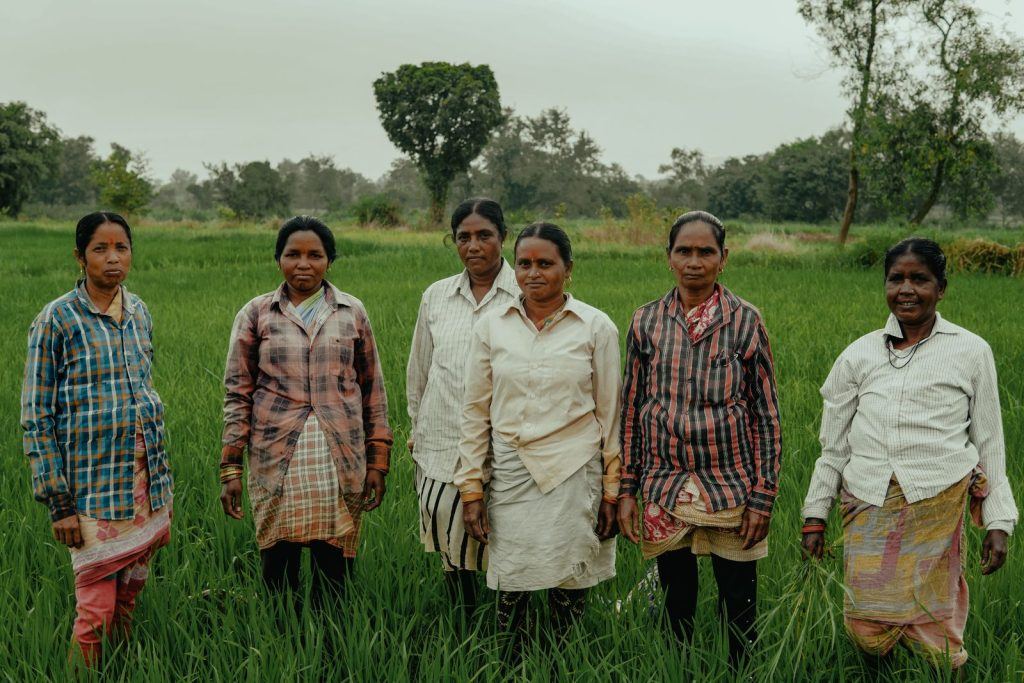Men standing together in a green field in India